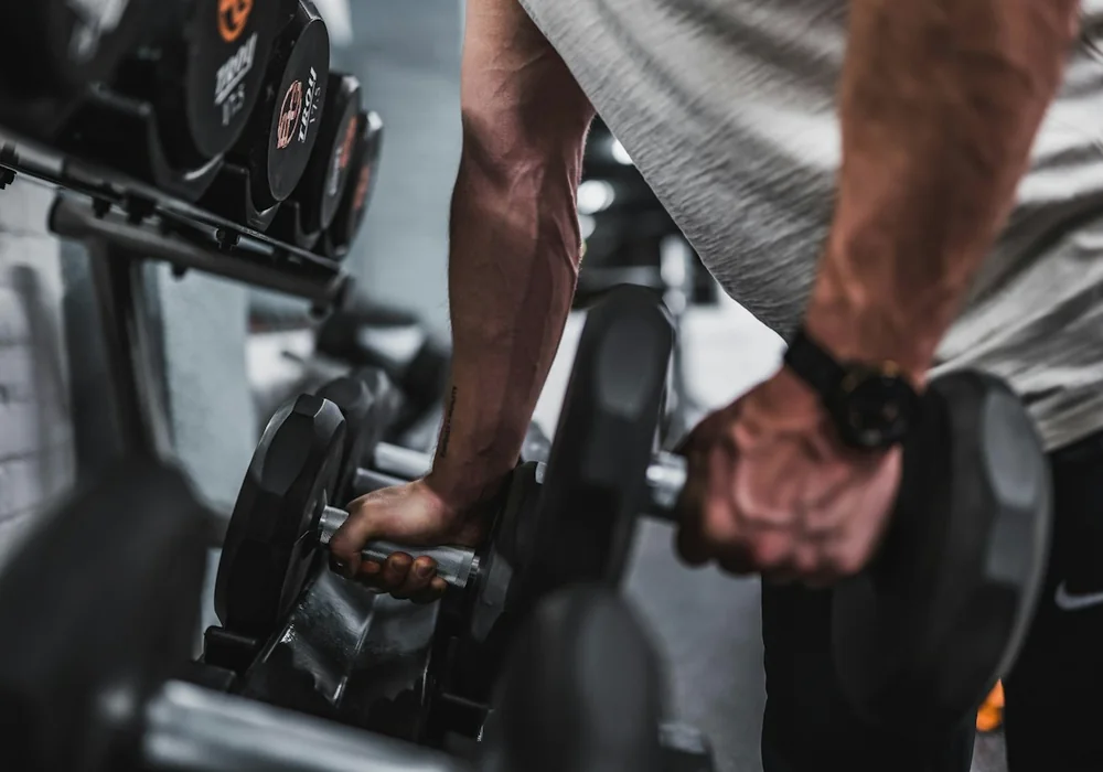 Lifter performing heavy dumbbell pressing