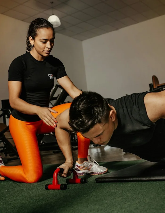 Coach guiding lifter through form mechanics